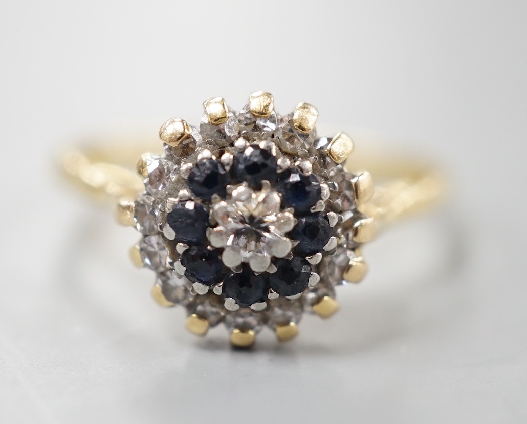 A 1960's 18ct gold, 18ct gold, sapphire and diamond set circular cluster ring, size O, gross weight 3.6 grams.
